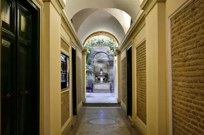 an empty hallway of a building with an archway at Palazzo Tridente Rooms in Rome