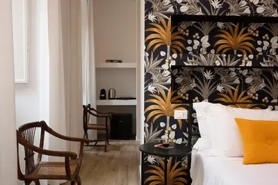 a bedroom with a black and gold patterned wall at Palazzo Tridente Rooms in Rome