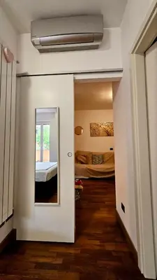a hallway with a room with two beds and a mirror at Dream Home Cortina in Rome