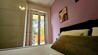 a bedroom with a large bed and a window at Dream Home Cortina in Rome