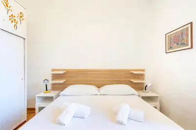 a bedroom with a white bed with two towels at Dome At Home in Rome