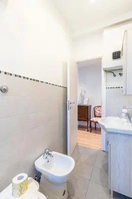 a bathroom with a toilet and a sink at Dome At Home in Rome