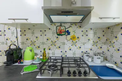 a kitchen with a stove top oven in a kitchen at Da Renny in Rome