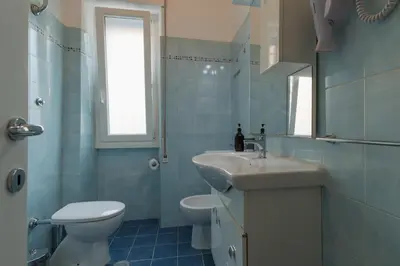 a bathroom with a sink and a toilet and a mirror at Da Renny in Rome