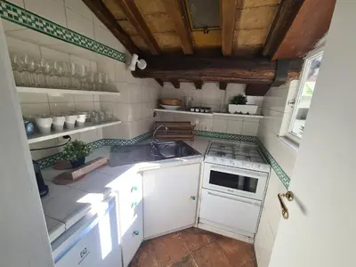 a small kitchen with a sink and a stove at Boutique Domus Spagna Ripetta in Rome