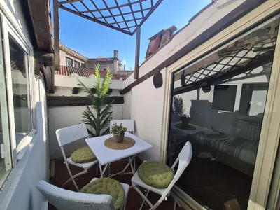 a small balcony with a table and chairs at Boutique Domus Spagna Ripetta in Rome