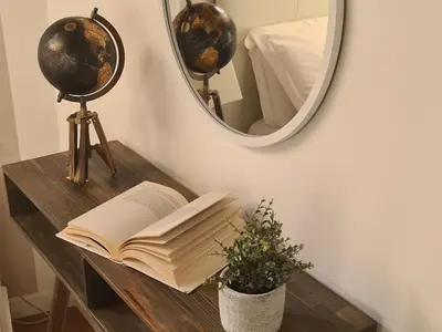 a table with an open book and a mirror at Boutique Domus Spagna Ripetta in Rome
