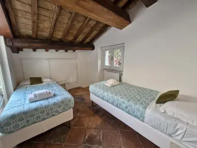 a bedroom with two beds and a window at Boutique Domus Spagna Ripetta in Rome