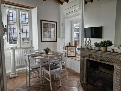 a living room with a table and a fireplace at Boutique Domus Spagna Ripetta in Rome