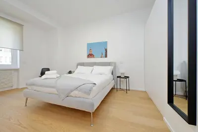 a white bedroom with a bed and a mirror at 4BNB - Charming Giuliana Apartment in Rome