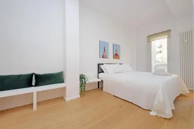 a white bedroom with a bed and a window at 4BNB - Charming Giuliana Apartment in Rome