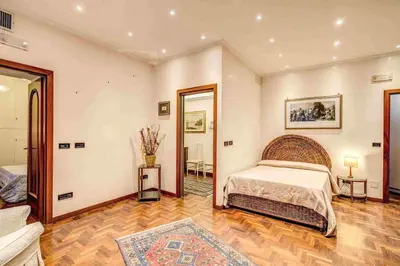 a large bedroom with a bed and a mirror at Feffyhouse in Rome