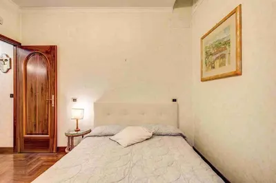 a bedroom with a bed and a picture on the wall at Feffyhouse in Rome