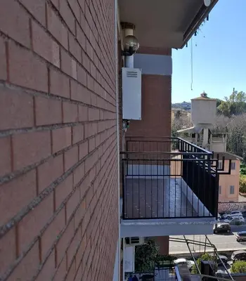 a brick building with a balcony on the side of it at Locazione turistica di Alberto in Rome