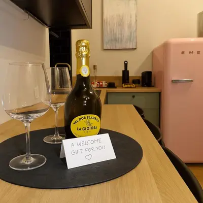 a bottle of wine sitting on a table with two glasses at éROMA - NAVONA Apartment in Rome