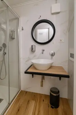 a bathroom with a sink and a mirror at éROMA - NAVONA Apartment in Rome
