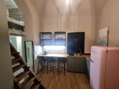 a kitchen with a table and chairs and a refrigerator at éROMA - NAVONA Apartment in Rome