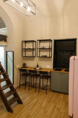 a kitchen with a table and chairs in a room at éROMA - NAVONA Apartment in Rome