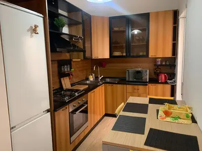 a kitchen with wooden cabinets and a white refrigerator at Trastevere AURA - Your Roman home with SOUL in Rome