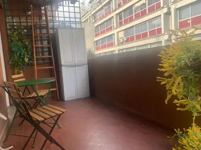 a balcony with a door and a table and a chair at Trastevere AURA - Your Roman home with SOUL in Rome