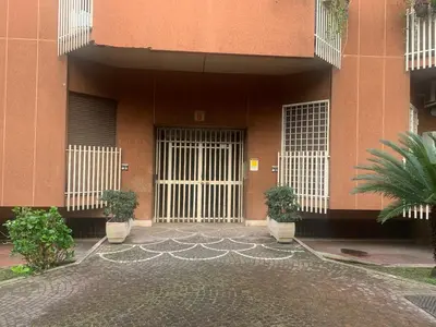a building with doors and plants in front of it at Trastevere AURA - Your Roman home with SOUL in Rome