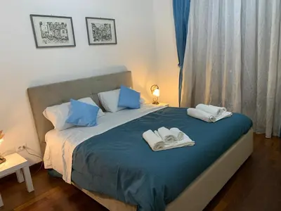 a bedroom with a bed with towels on it at Trastevere AURA - Your Roman home with SOUL in Rome
