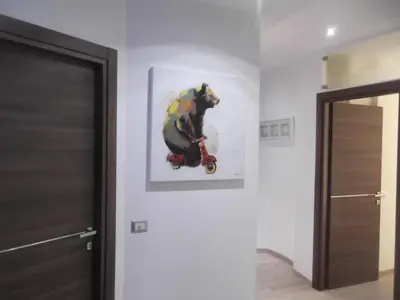 a painting of a bear on a scooter on a wall at Gloria Vatican Bijou in Rome