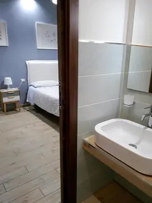a bathroom with a sink and a bed at Gloria Vatican Bijou in Rome