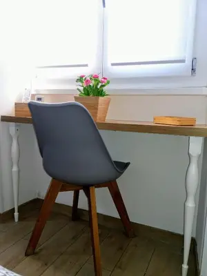 a desk with a chair in front of a window at Gloria Vatican Bijou in Rome