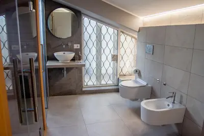 a bathroom with two sinks and two toilets at gandino apartment in Rome