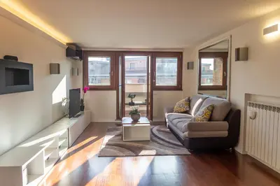 a living room with a couch and a tv at gandino apartment in Rome