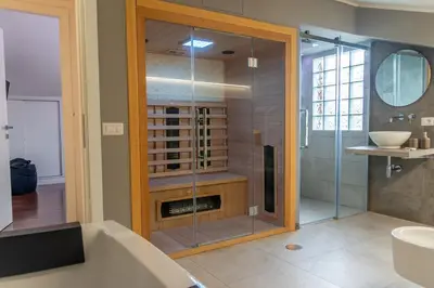 a bathroom with a shower with a tub and a sink at gandino apartment in Rome