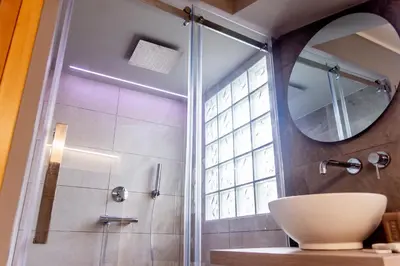 a bathroom with a shower with a sink and a mirror at gandino apartment in Rome
