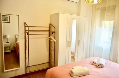a bedroom with a bed with towels and a mirror at Aurelio Vatican Apartment in Rome