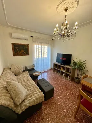 a living room with a couch and a tv at Aurelio Vatican Apartment in Rome