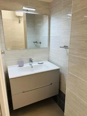 a bathroom with a sink and a mirror at Aurelio Vatican Apartment in Rome