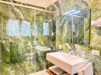 a bathroom with a sink and a shower at Saint Peter Rome - Luxury Apartments with 24H Guarded Parking in Rome