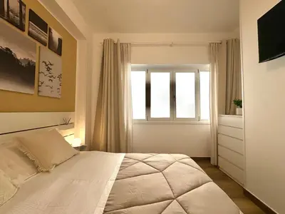 a bedroom with a white bed and a window at Saint Peter Rome - Luxury Apartments with 24H Guarded Parking in Rome