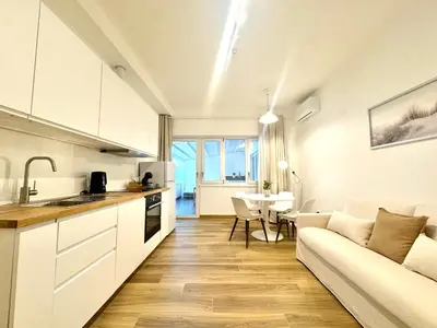 a kitchen and living room with a couch and a table at Saint Peter Rome - Luxury Apartments with 24H Guarded Parking in Rome
