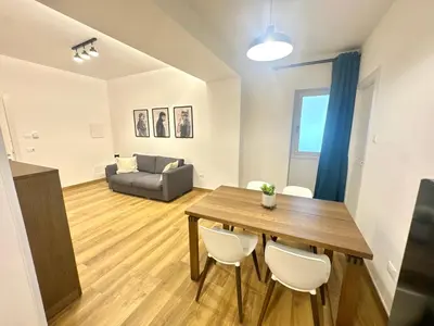 a living room with a table and chairs and a couch at Saint Peter Rome - Luxury Apartments with 24H Guarded Parking in Rome