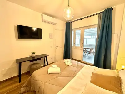 a bedroom with a bed and a desk and a window at Saint Peter Rome - Luxury Apartments with 24H Guarded Parking in Rome