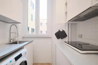 a white kitchen with a sink and a dishwasher at Vatican Museums - Modern flat with Wi-Fi & Netflix in Rome