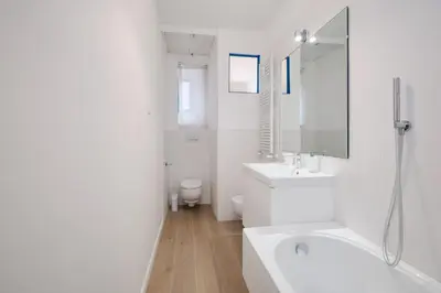 a white bathroom with a sink and a toilet at Vatican Museums - Modern flat with Wi-Fi & Netflix in Rome