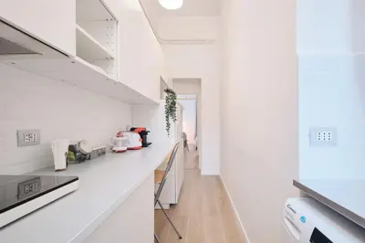 a kitchen with white walls and a white counter top at Vatican Museums - Modern flat with Wi-Fi & Netflix in Rome