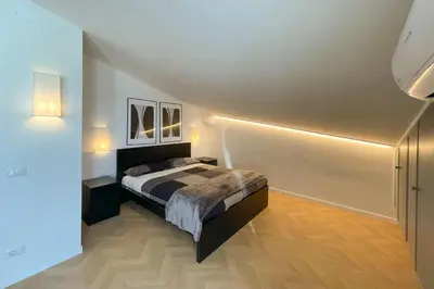 a bedroom with a bed and two pictures on the wall at Appartamento al Vaticano in Rome