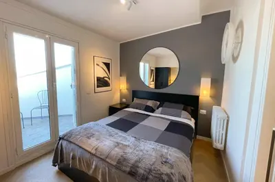 a bedroom with a large bed and a mirror at Appartamento al Vaticano in Rome