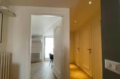 a hallway with a white door and a room at Appartamento al Vaticano in Rome