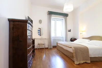 a bedroom with a large bed and a large dresser at Stella House in Rome