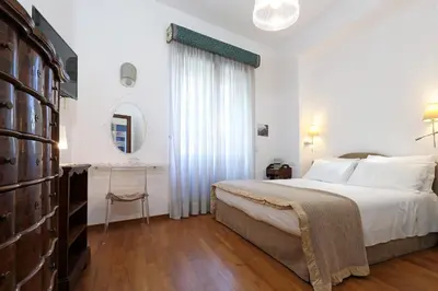 a bedroom with a large bed and a table at Stella House in Rome