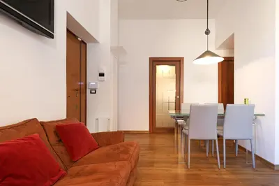 a living room with a couch and a table and chairs at Stella House in Rome